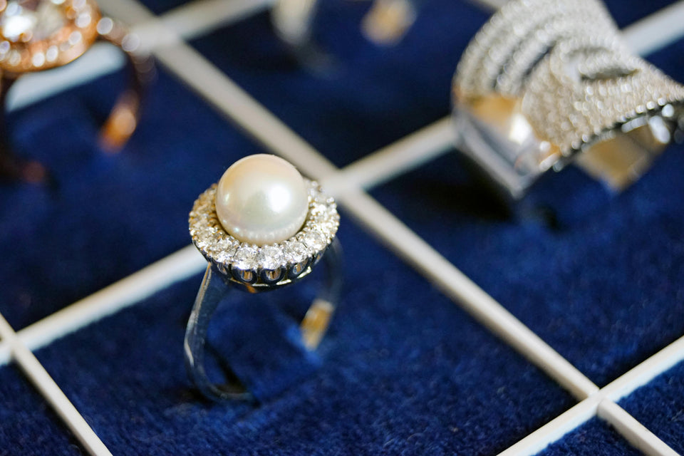 Pearl ring with diamond accents displayed as part of timeless jewelry collection.