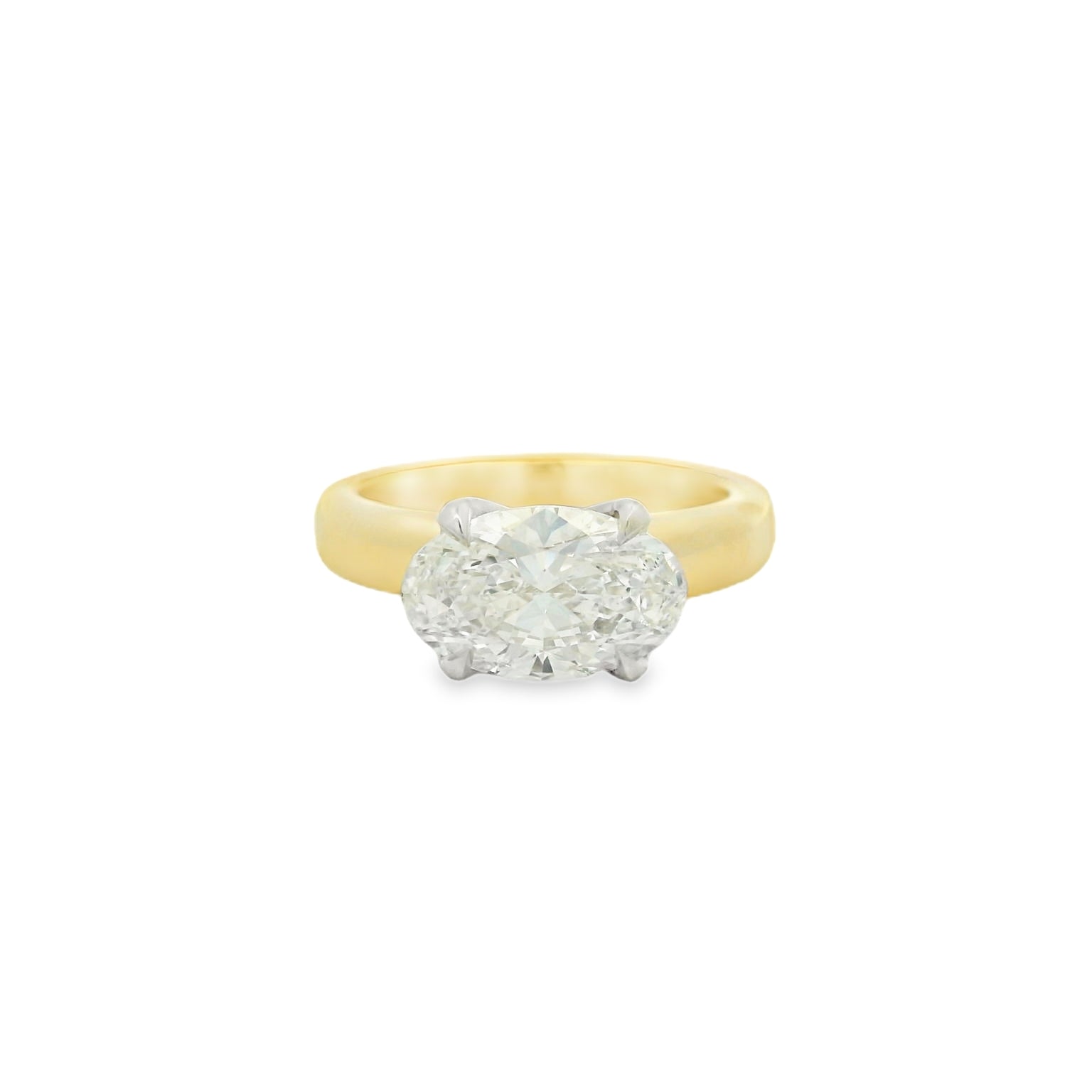 14kt yg band with 14k wg head east west oval prong set