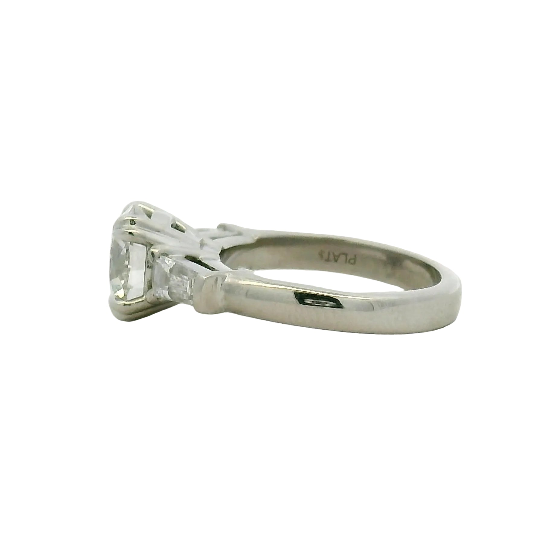 Round Brilliant and Baguette Diamond Engagement Ring in Platinum