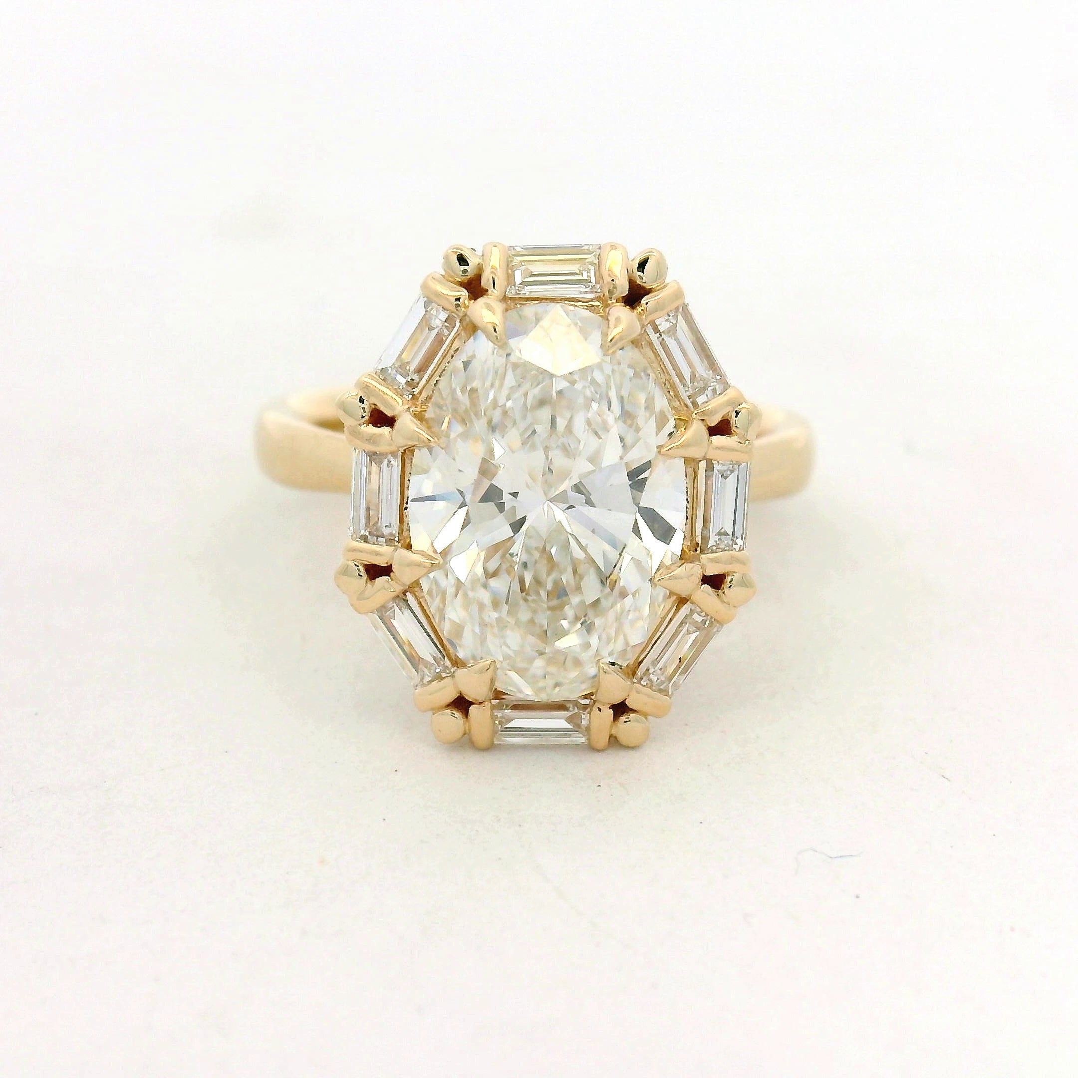 Oval Diamond Baguette Halo Ring in Yellow Gold