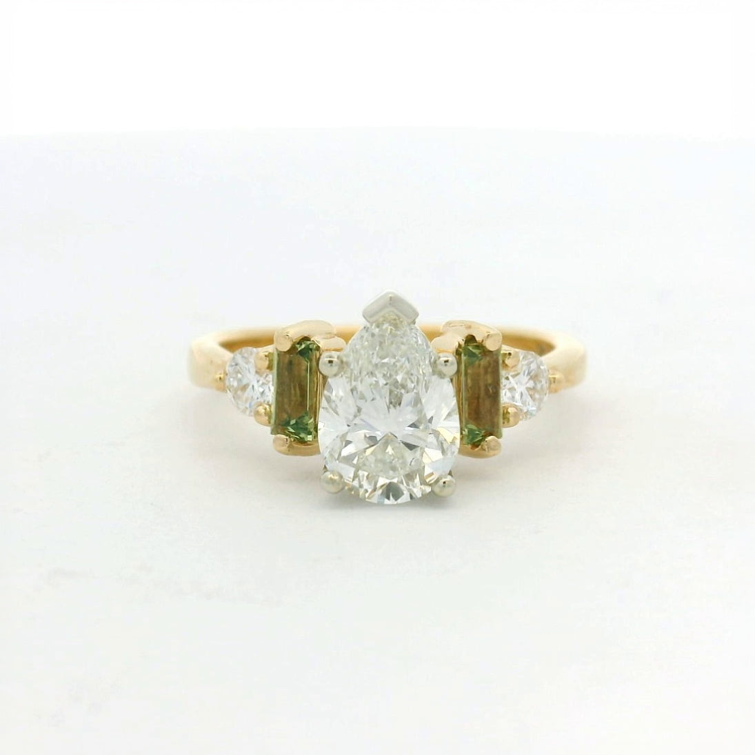 14KT two tone pear diamond with green sapphire and diamond side stones engagement ring