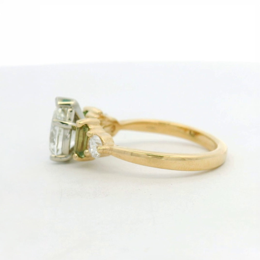 14KT two tone pear diamond with green sapphire and diamond side stones engagement ring