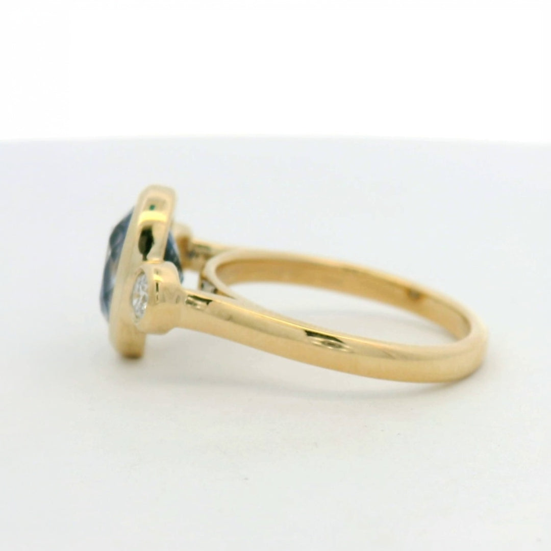 14KT yellow gold bezel set three stone sapphire and diamond engagement ring