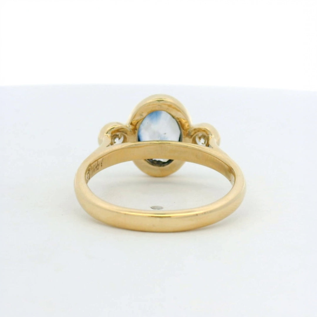 14KT yellow gold bezel set three stone sapphire and diamond engagement ring