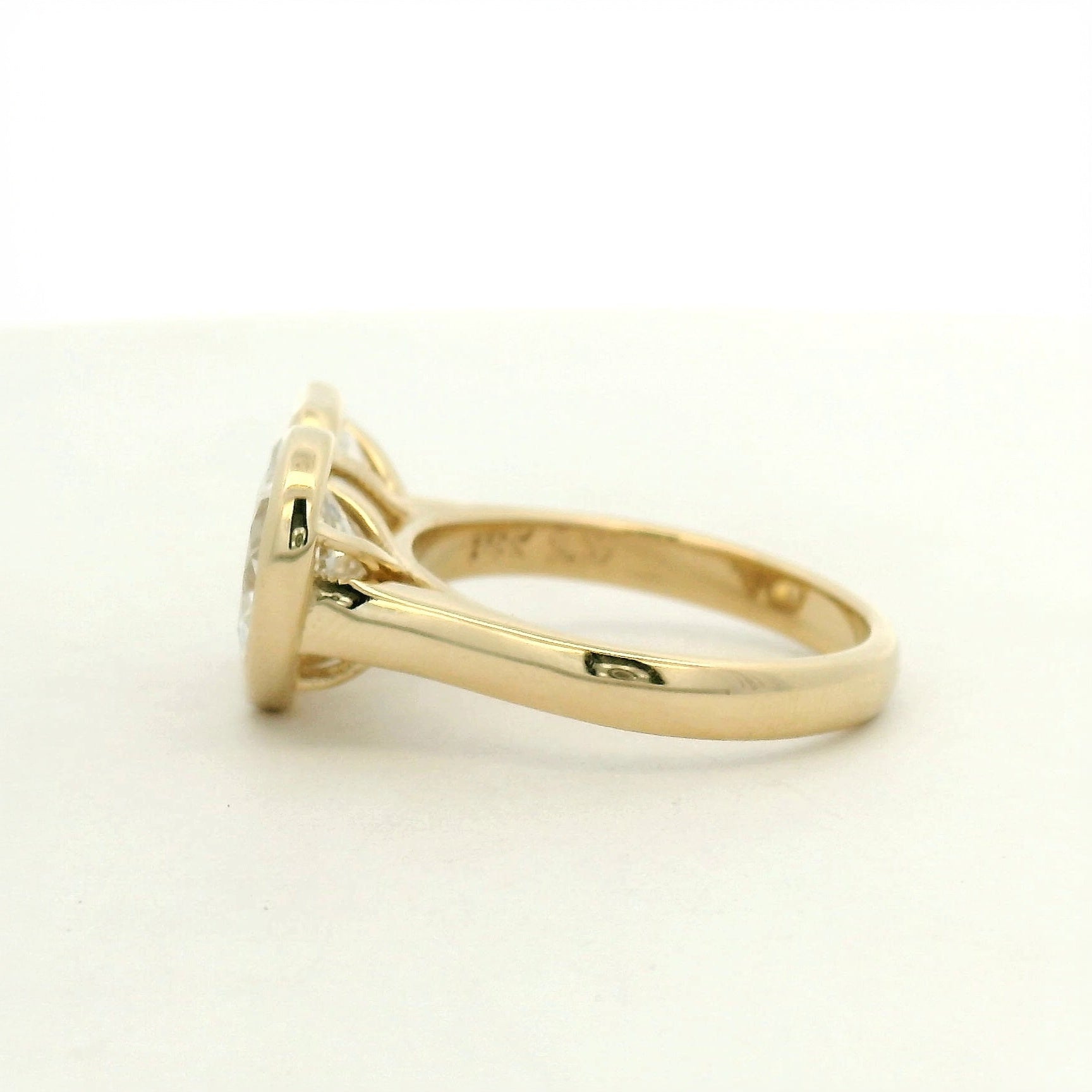 14k yellow gold toi et moi style engagement ring with an emerald and a pear cut diamond