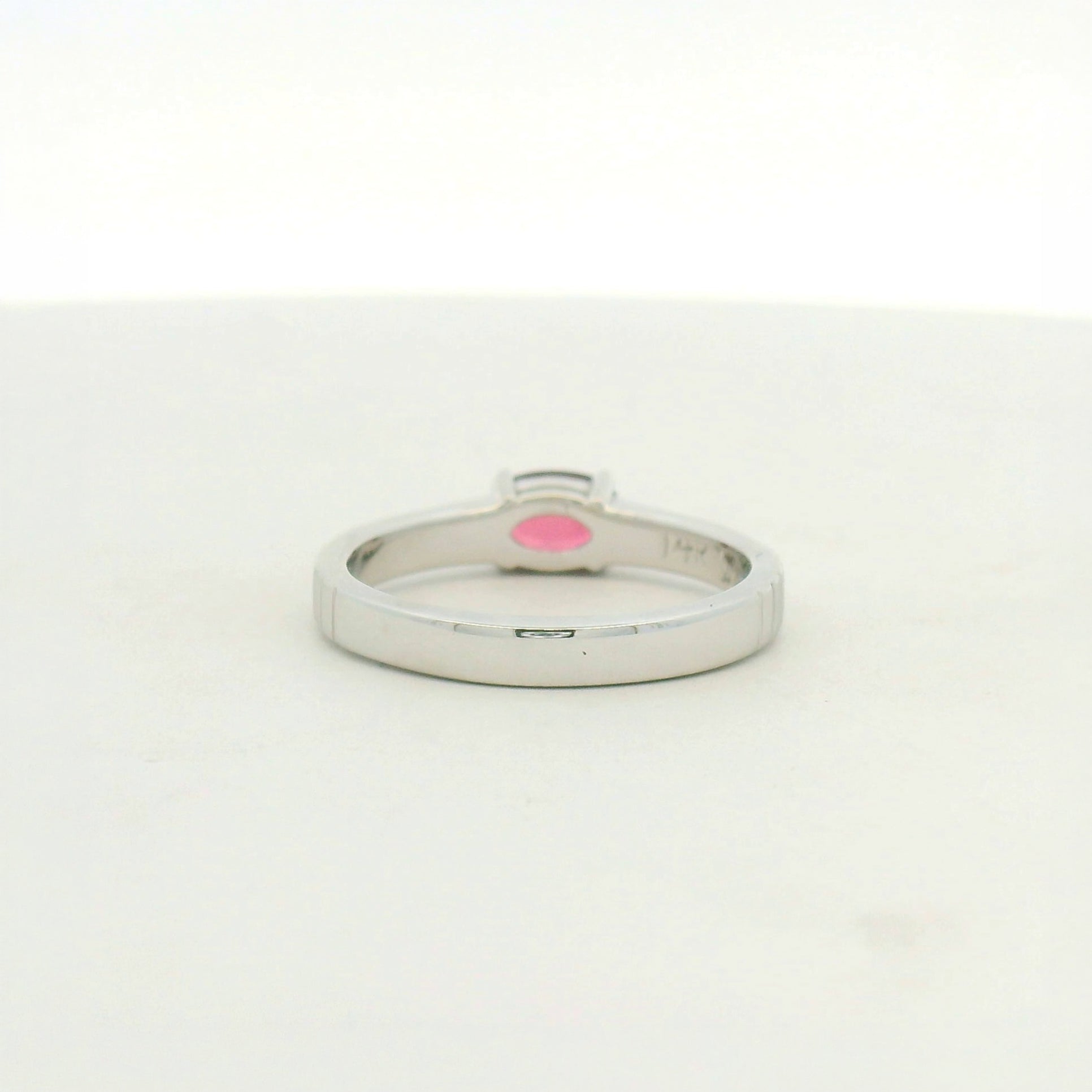 14kt white gold east west set ruby with banded texture on shank