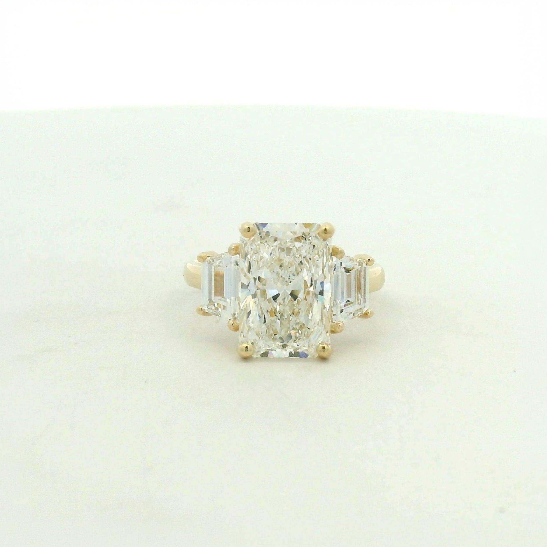 14kt yellow gold three stone ring one radiant & two trapezoid side stones