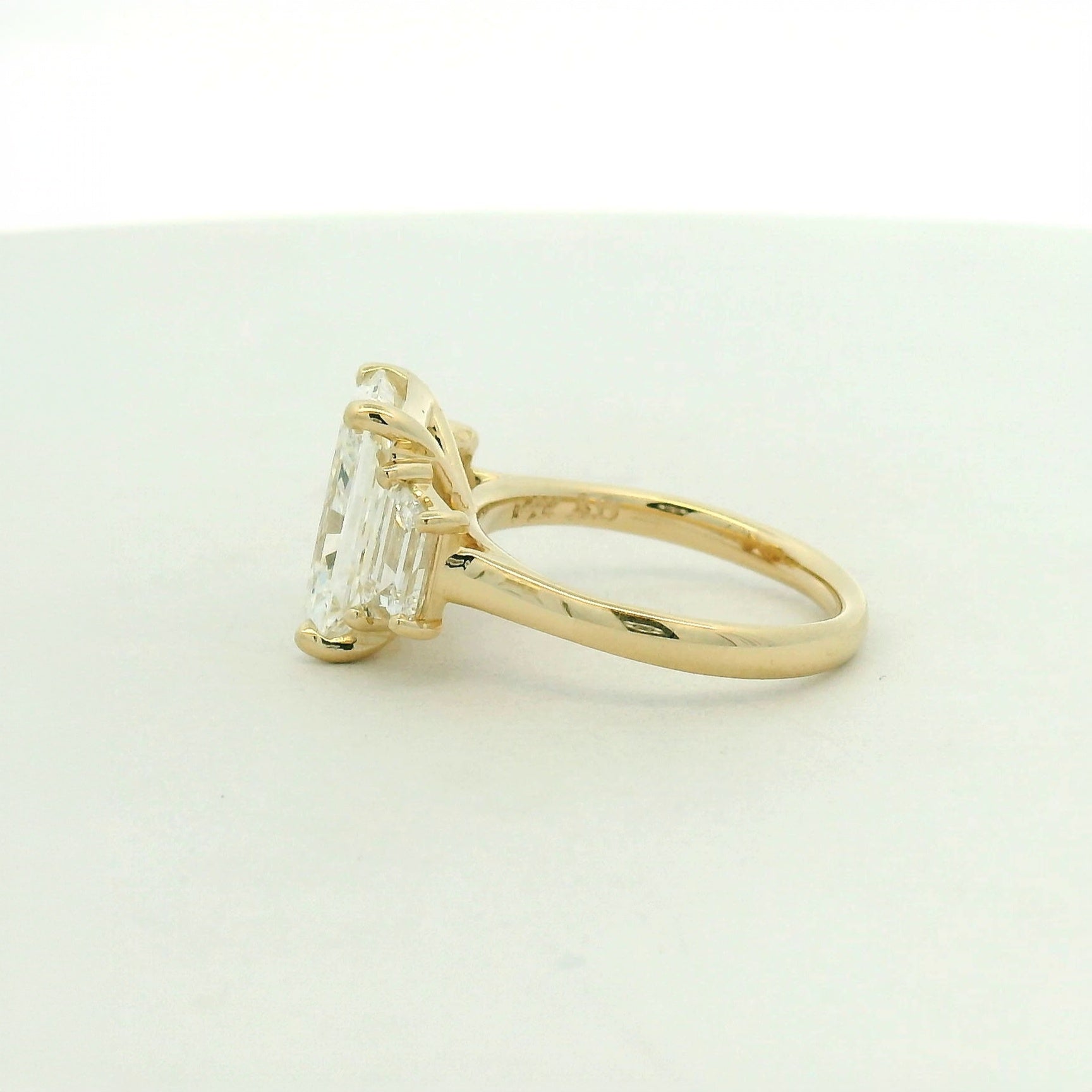 14kt yellow gold three stone ring one radiant & two trapezoid side stones
