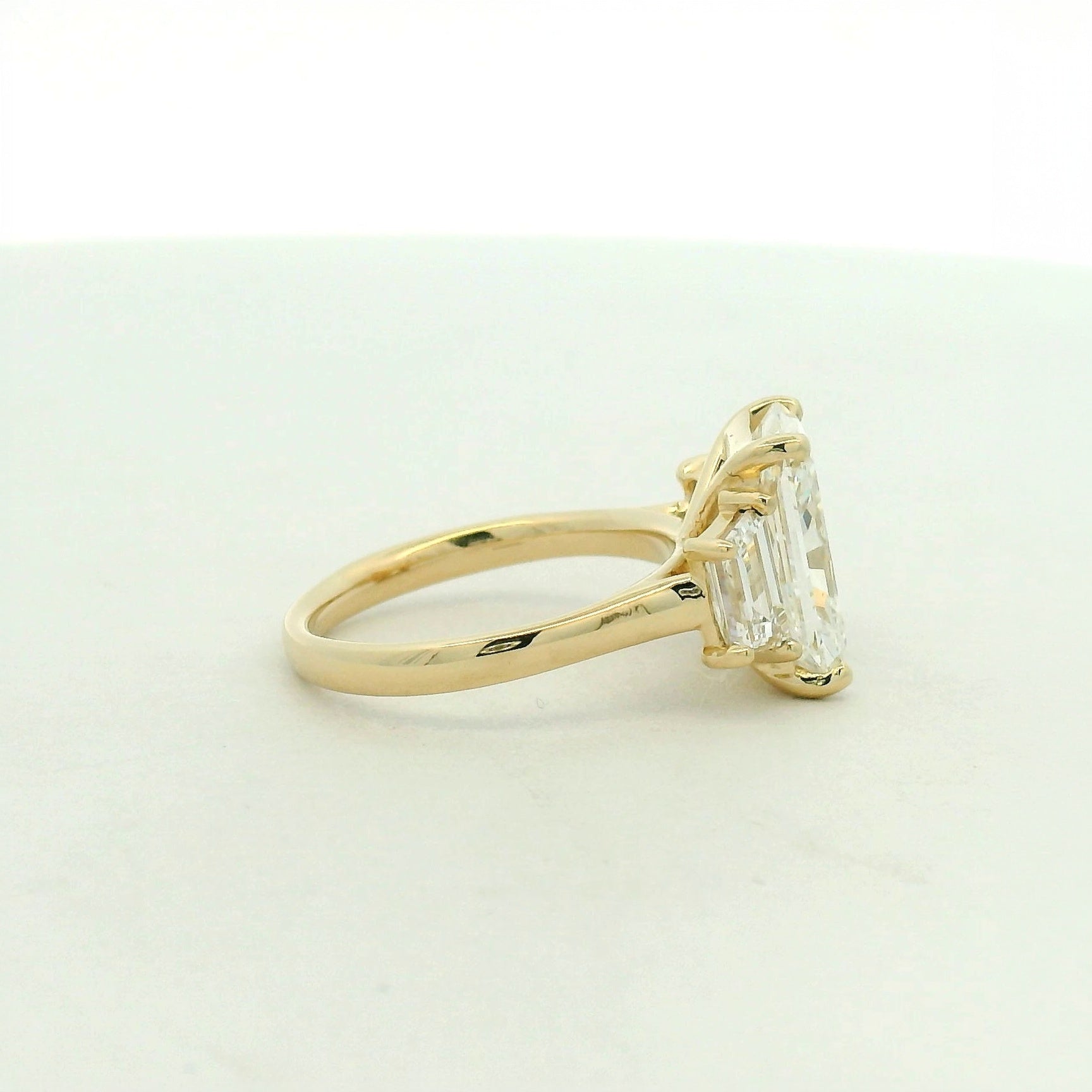 14kt yellow gold three stone ring one radiant & two trapezoid side stones