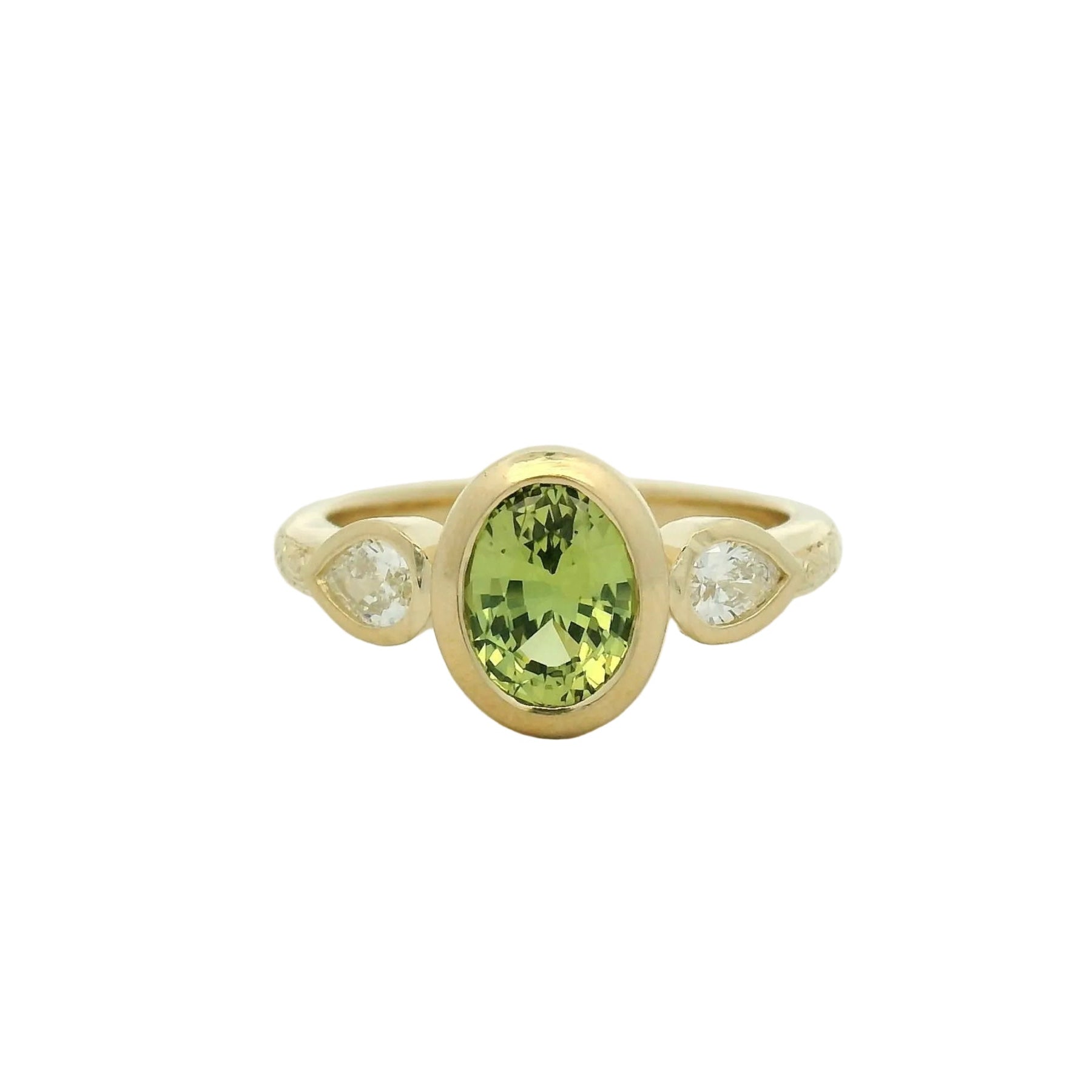 14k yellow gold oval green sapphire bezel set with pear lab diamond side stones and hand engraving engagement ring