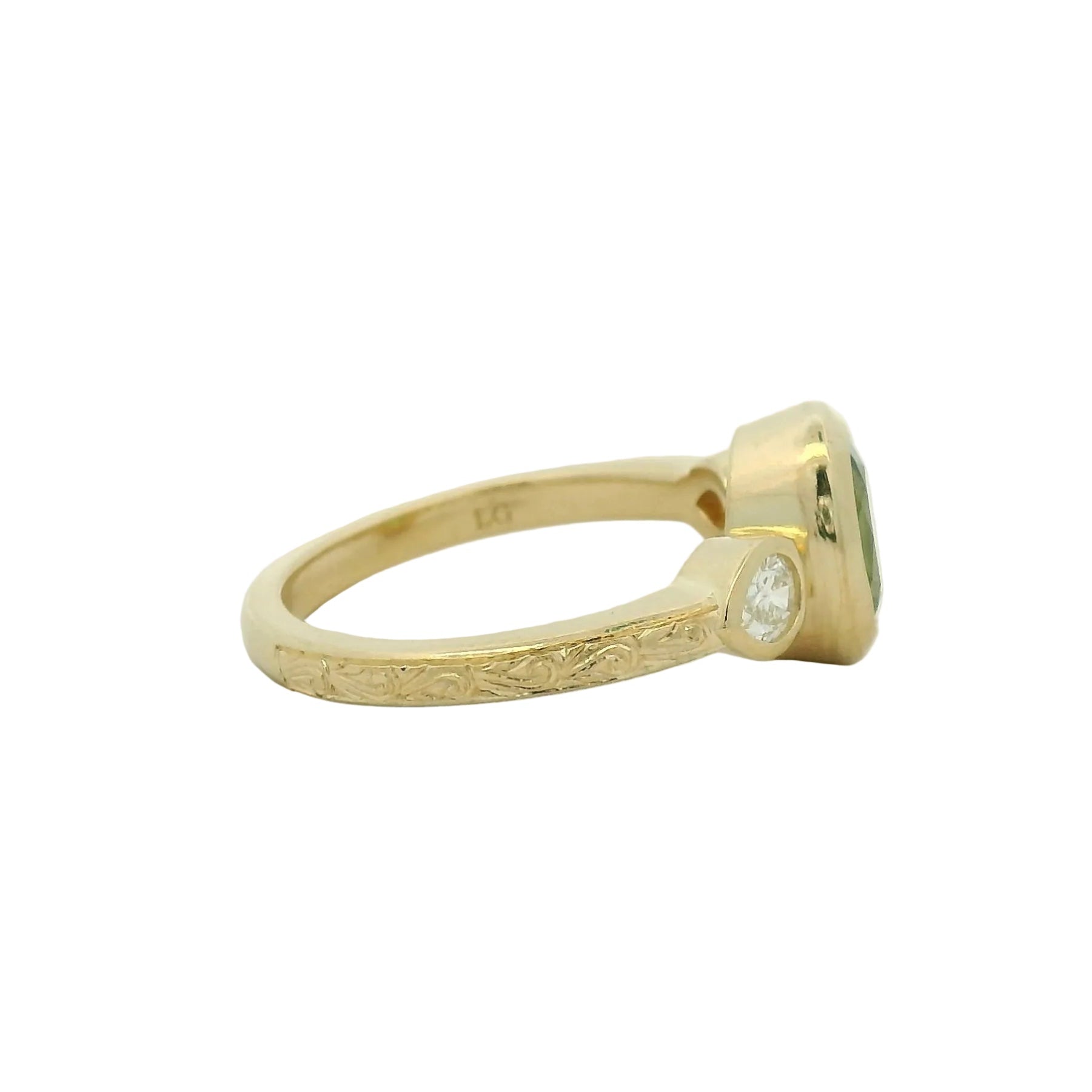 14k yellow gold oval green sapphire bezel set with pear lab diamond side stones and hand engraving engagement ring