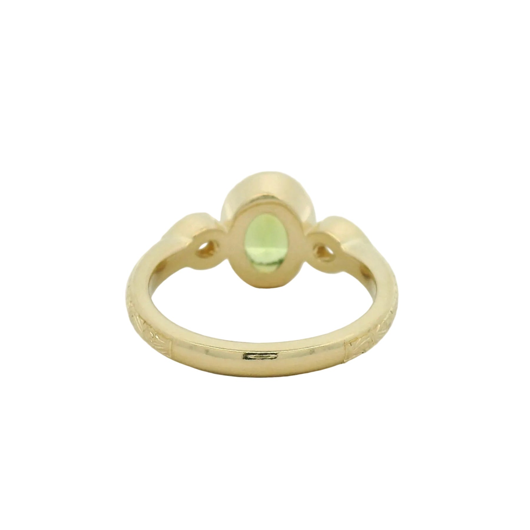 14k yellow gold oval green sapphire bezel set with pear lab diamond side stones and hand engraving engagement ring