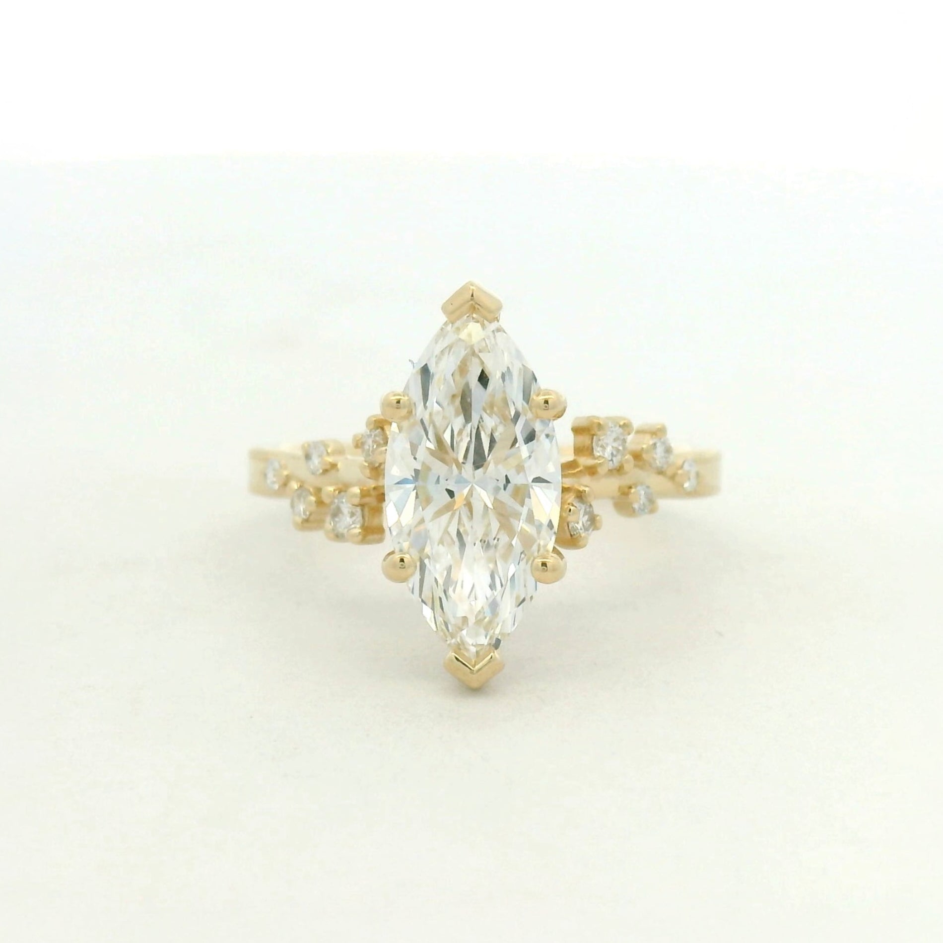 14kt yellow gold ring marquise center stone and scattered side stone
