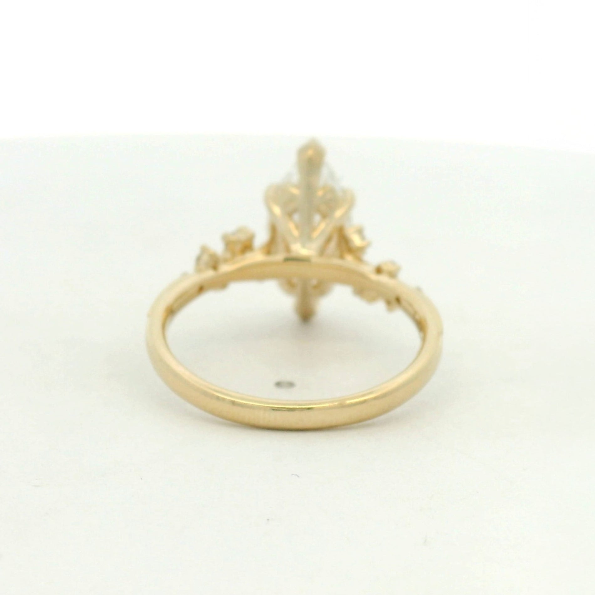 14kt yellow gold ring marquise center stone and scattered side stone
