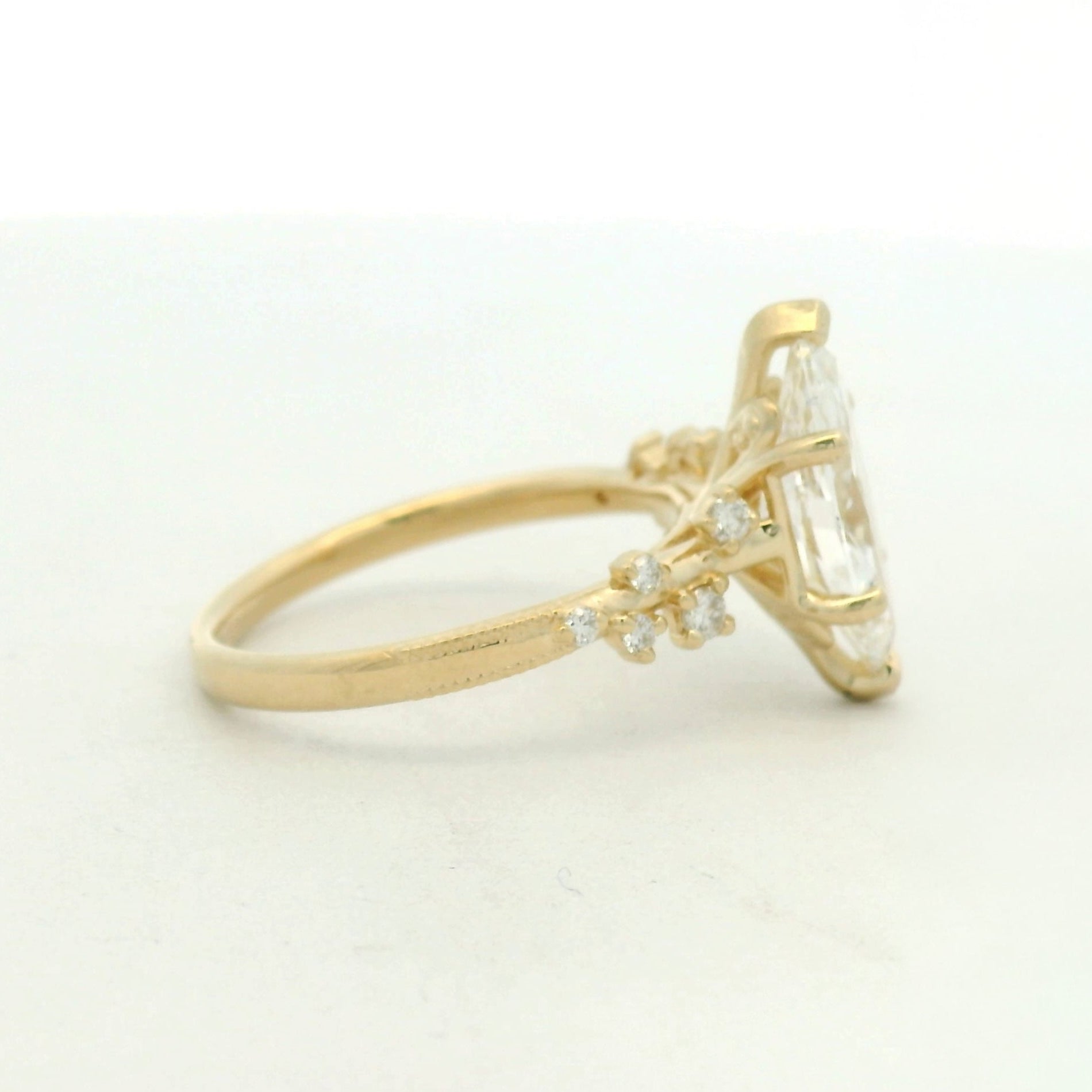 14kt yellow gold ring marquise center stone and scattered side stone