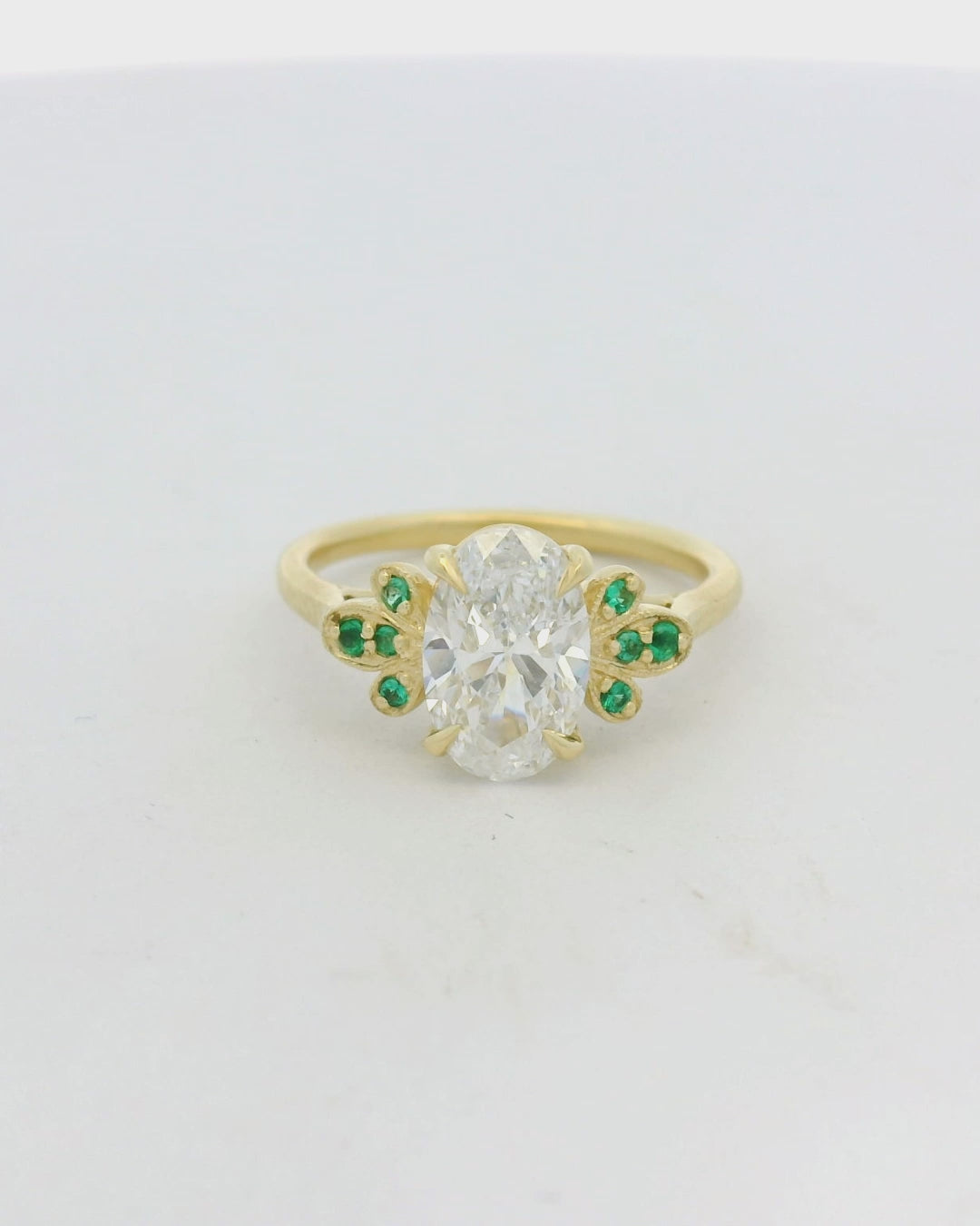 18KT Yellow Gold Oval Diamond Emerald Side Stone engagement ring