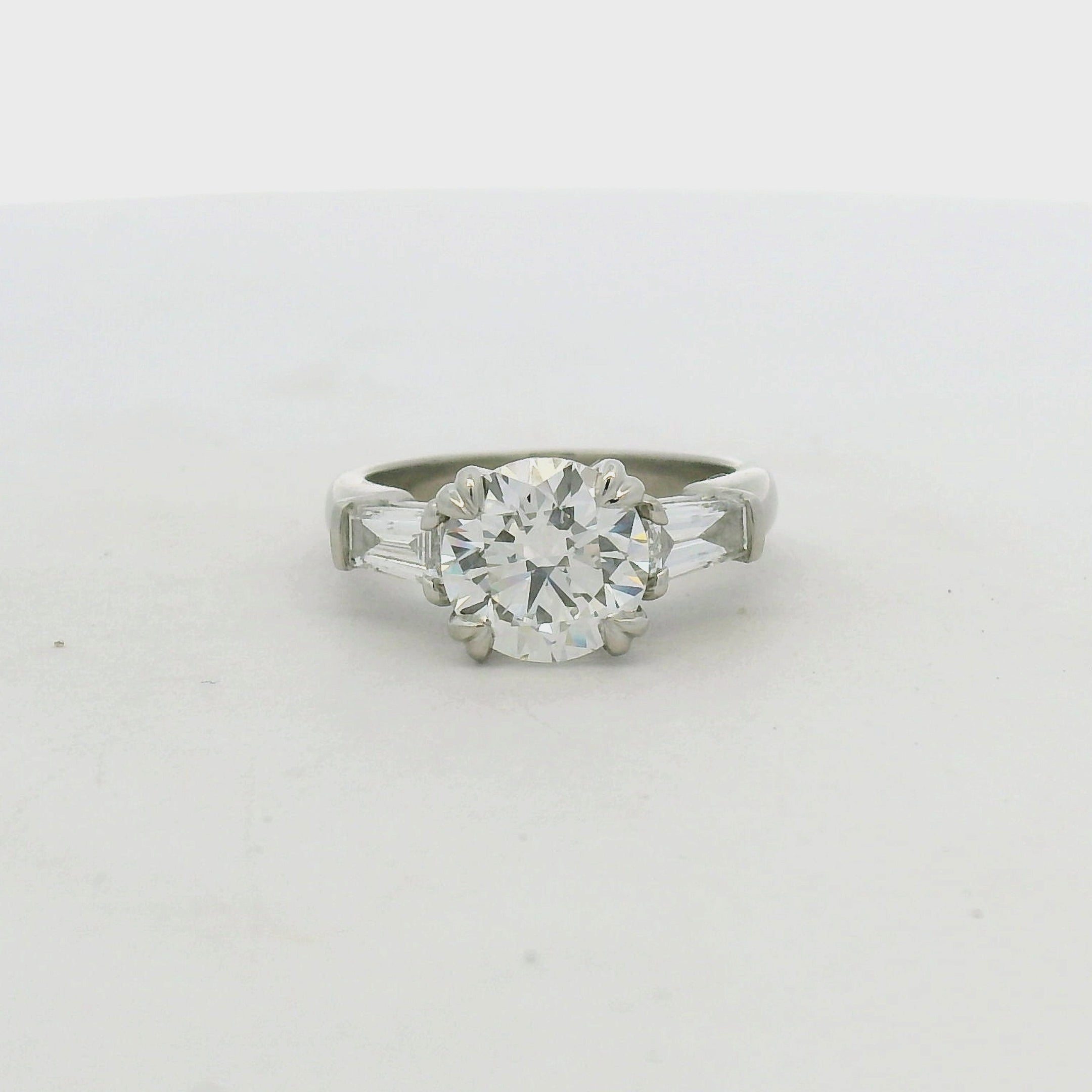 Round Brilliant and Baguette Diamond Engagement Ring in Platinum