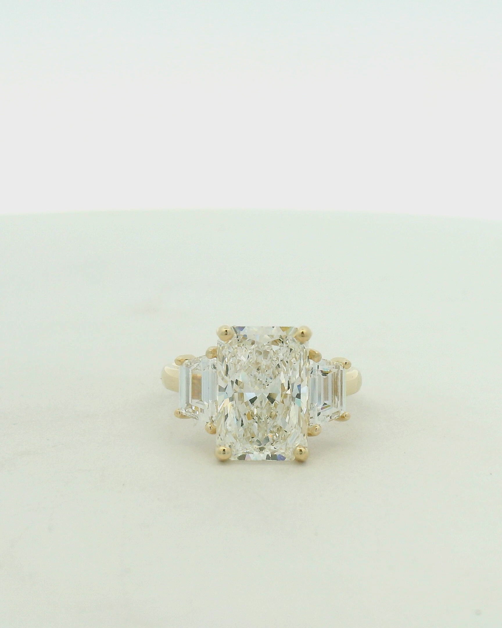 14kt yellow gold three stone ring one radiant & two trapezoid side stones