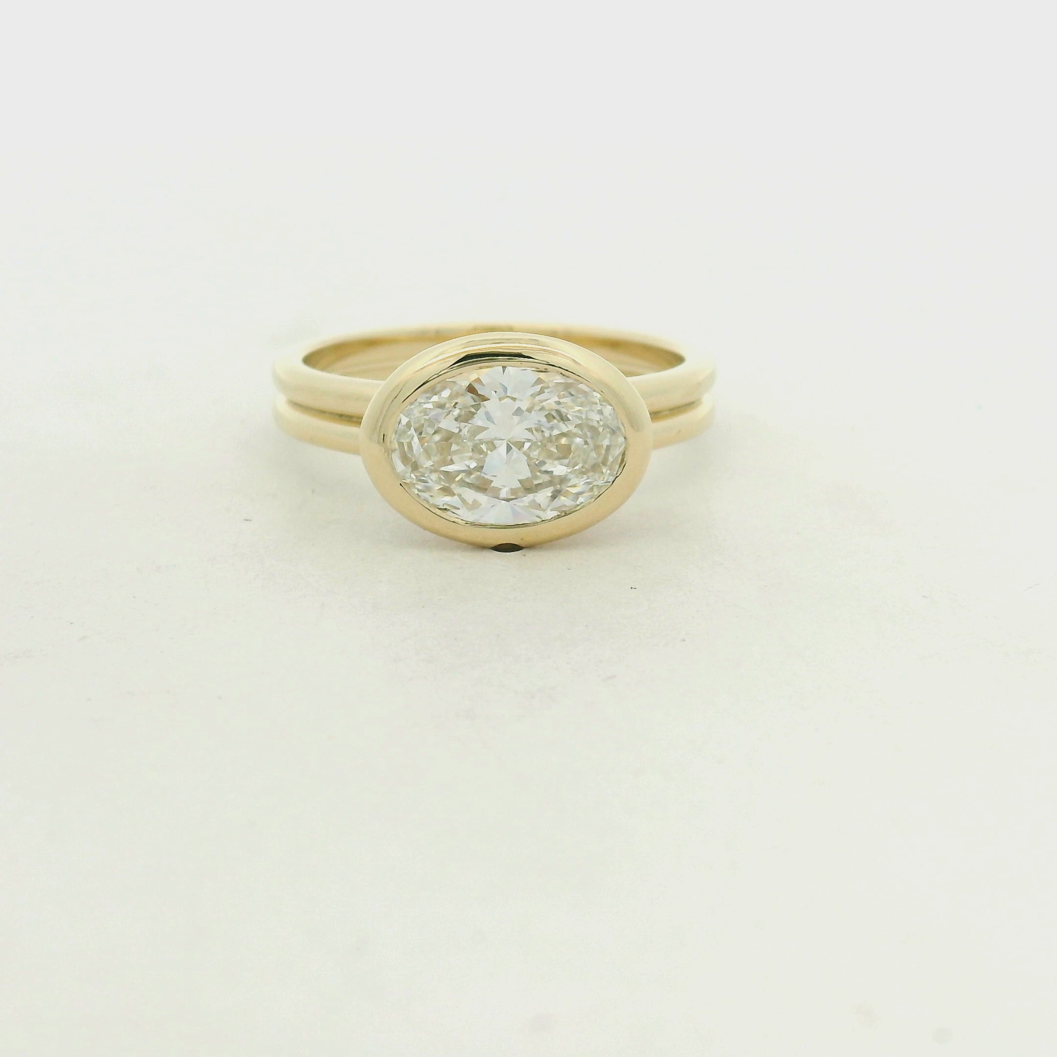 East-West Bezel Set Oval Diamond Solitaire Ring in Yellow Gold