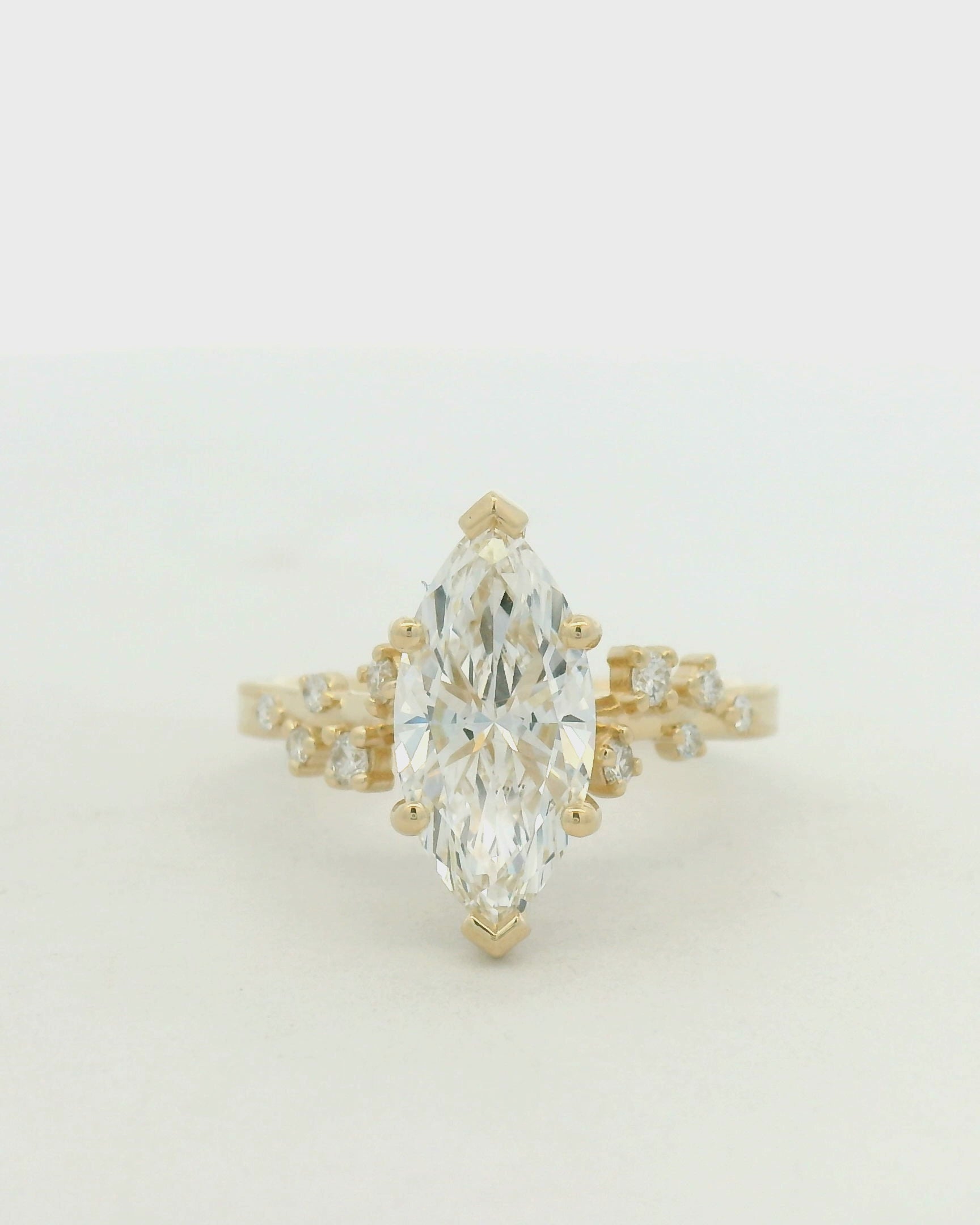 14kt yellow gold ring marquise center stone and scattered side stone