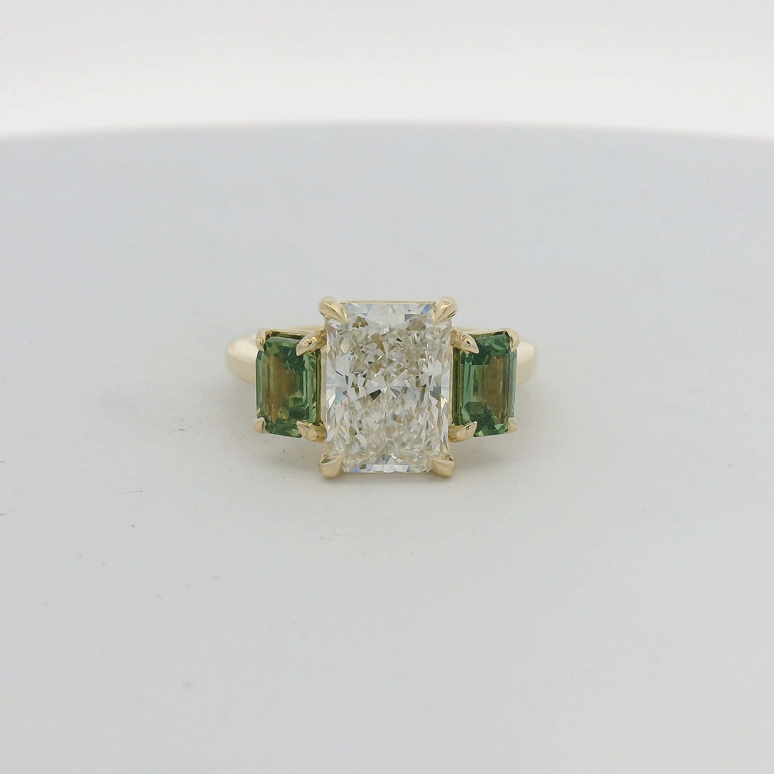 14KT Yellow Gold Three Stone Radiant Diamond and Green Sapphire Engagement Ring