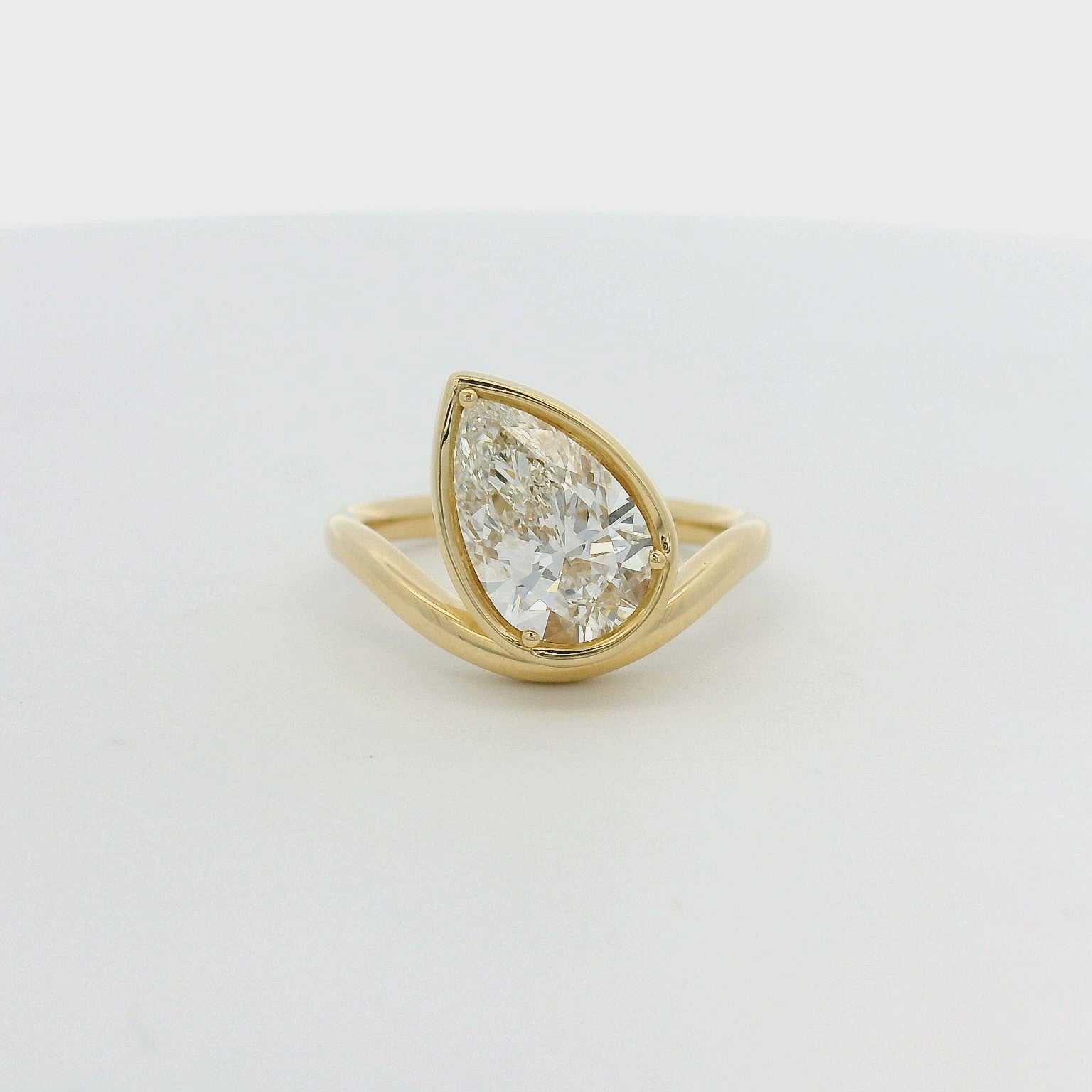 14KT yellow gold curved bezel set 2ct pear lab-grown diamond engagement ring