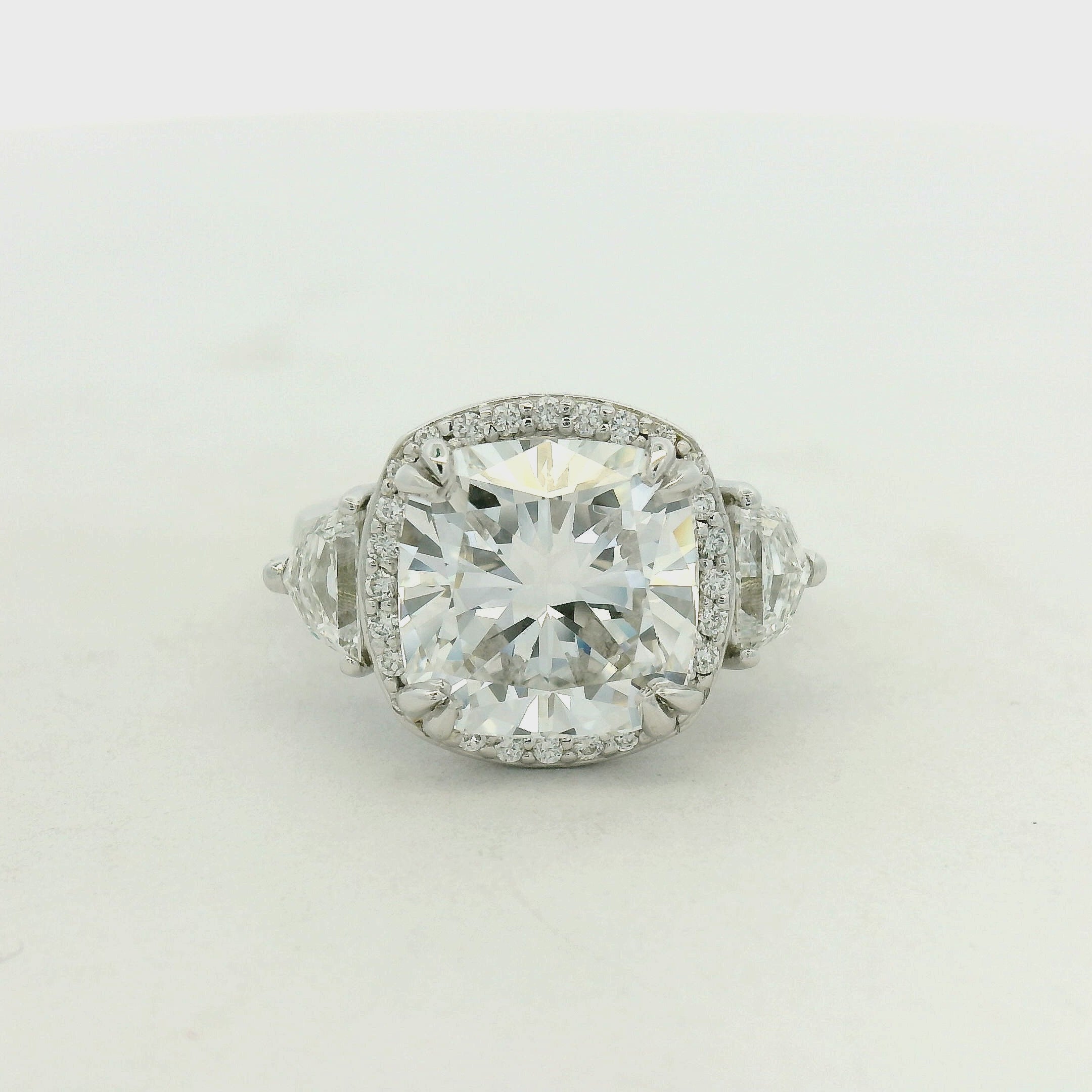 THREE STONE RING WITH HALO