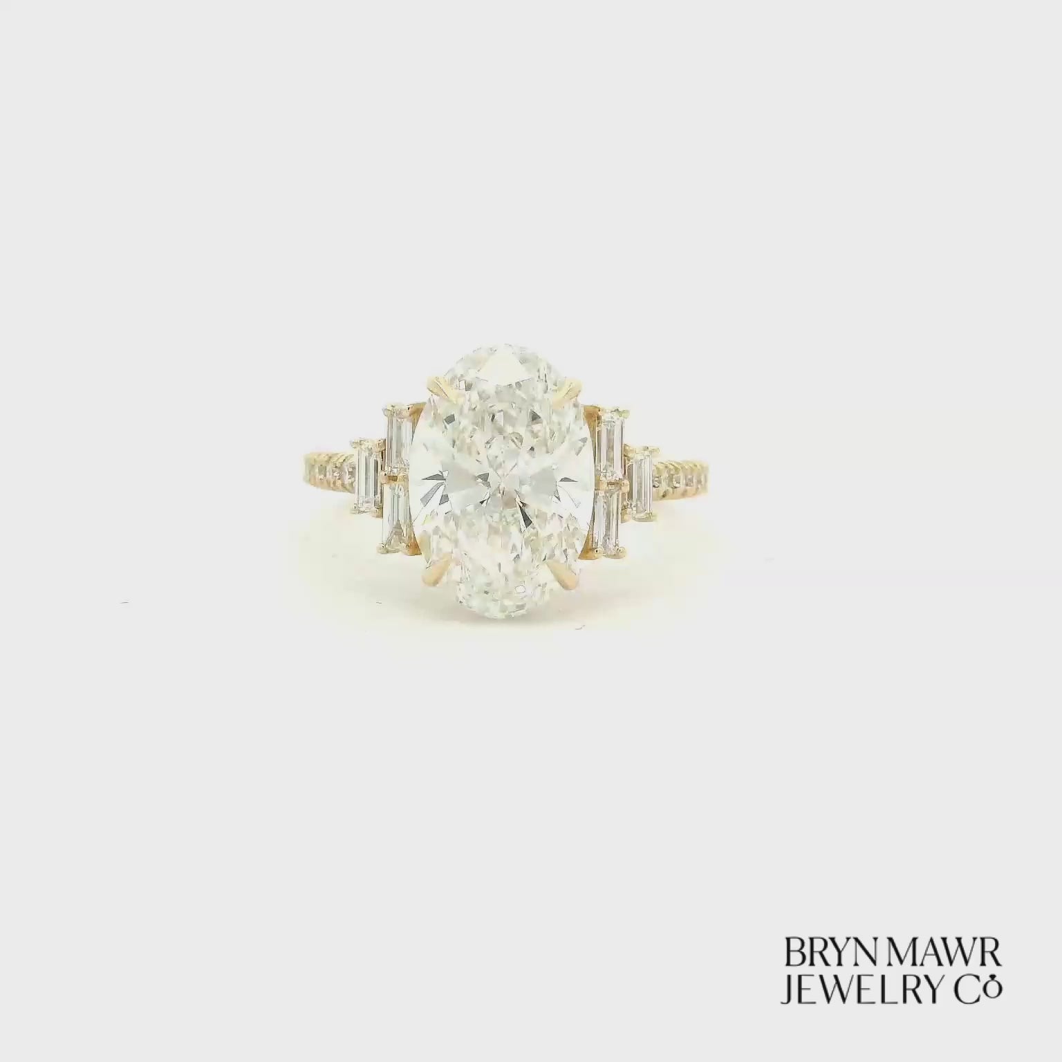 Yellow Gold Oval Diamond Ring with Stepped Baguette Accents
